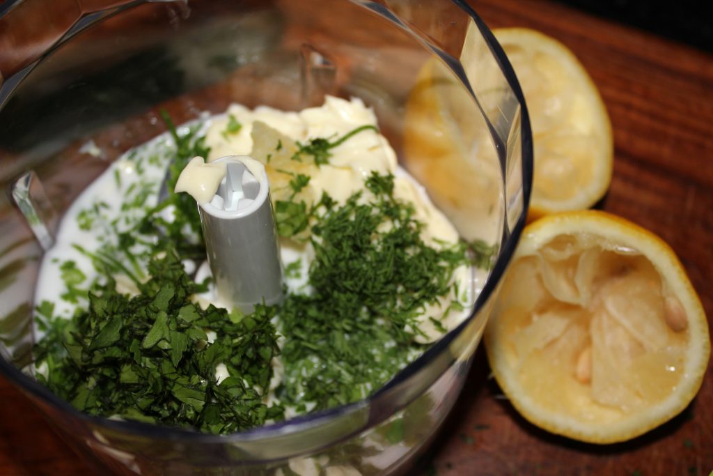 Ingredients for creamy herb dressing in food processor